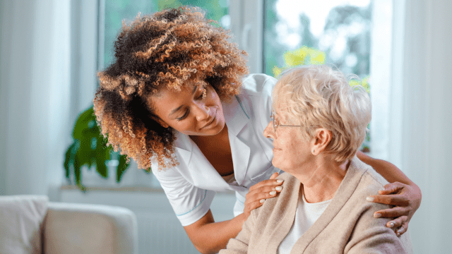 Nurse helping elderly woman