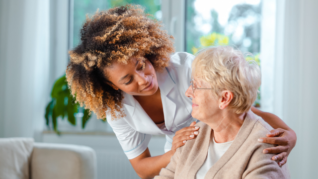 Nurse helping elderly woman. Nursing care in Andover. Home care